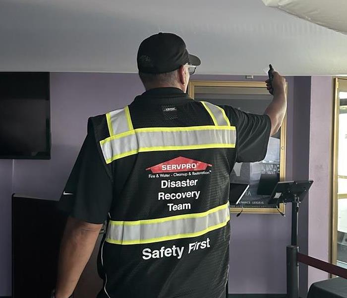 Servpro® Disaster Recovery Professional Crew Member Taking Water Measurement